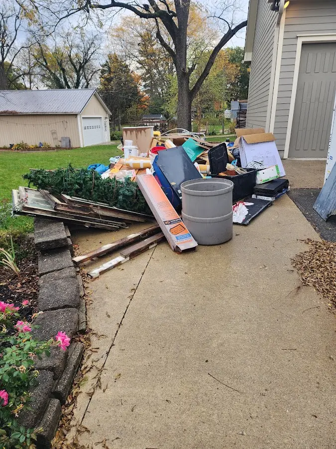 Dumpster being loaded with debris for 12 Yard Dumpster Rental in East Franklin